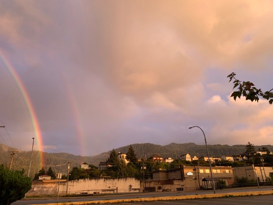 view of Prince Rupert from downtown at sunset with a double rainbow