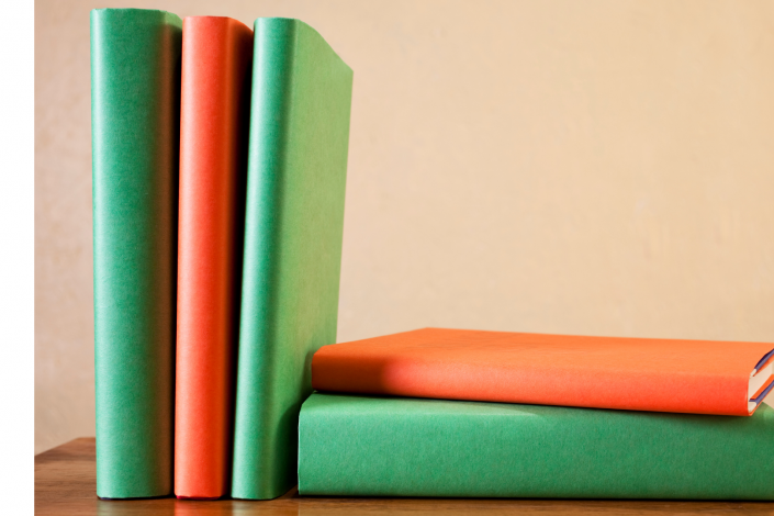 orange and green books on a table