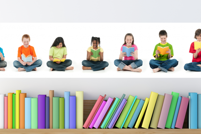 A row of kids sitting cross legged in brightly colored shirts above a row of rainbow colored books