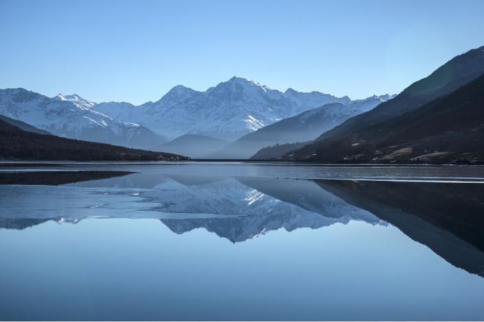 mountain range reflected in water