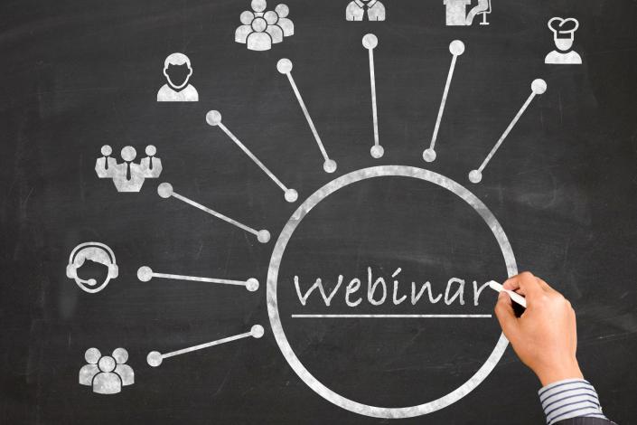 chalkboard with chalk drawing of circle. within circle reads webinar. lines from circle go out and lead to drawings of people watching webinar