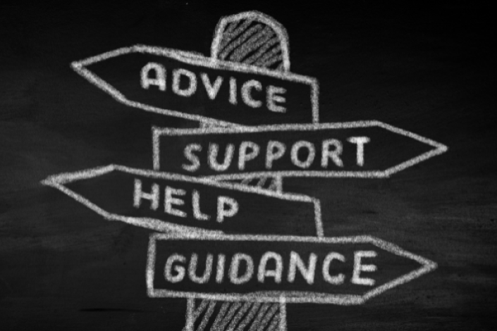 chalkboard with a signpost featuring four arrows pointing in different arrows on it. arrows read from top to bottom: advice, support, help, guidance